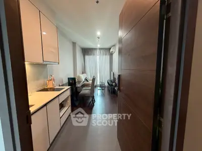 Modern open-layout kitchen and living room with sleek design and natural light.