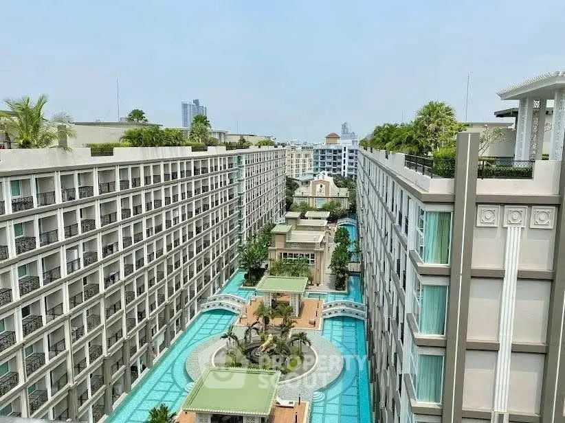 Luxurious condominium complex with stunning pool and city views.
