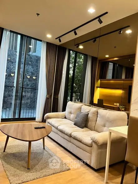 Modern living room with large windows and stylish furniture in a luxury apartment.