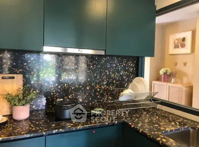 Stylish kitchen with terrazzo countertops and modern green cabinetry