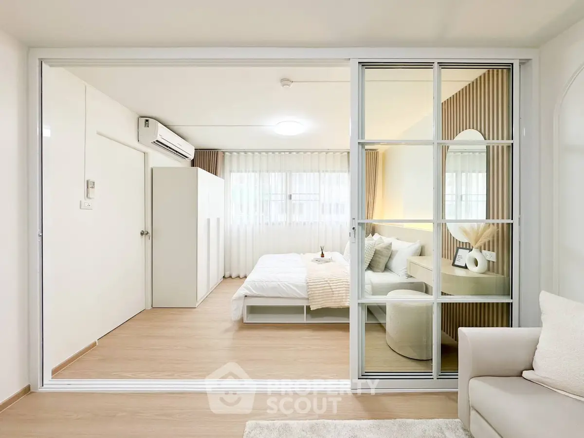 Modern bedroom with sliding glass doors and cozy decor