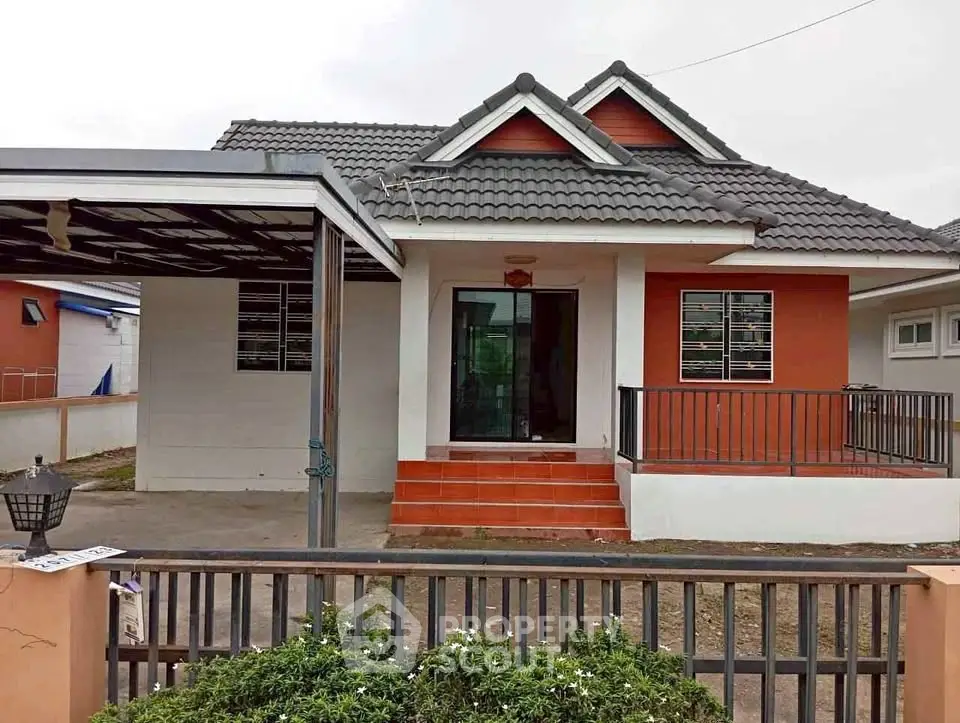 Charming single-story house with modern roof and inviting front porch.