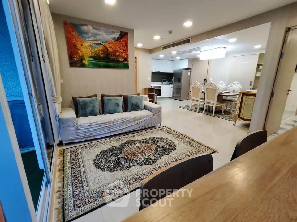 Spacious open-plan living room with elegant decor and modern kitchen