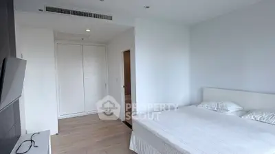 Modern minimalist bedroom with white decor and built-in wardrobe