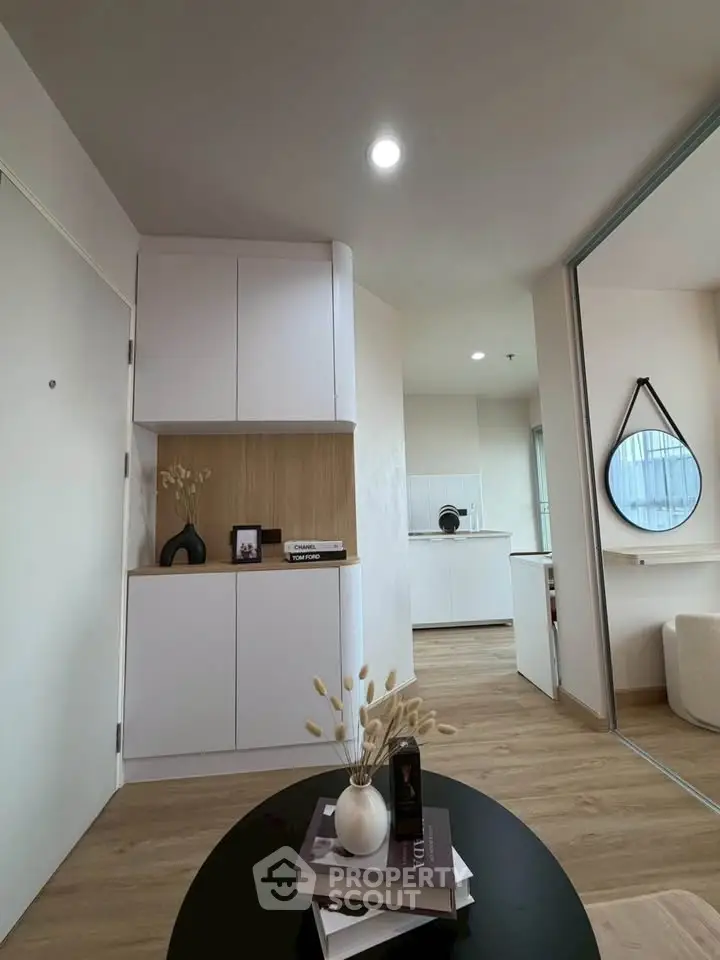 Modern apartment interior with stylish decor and open layout, featuring sleek cabinetry and elegant furnishings.