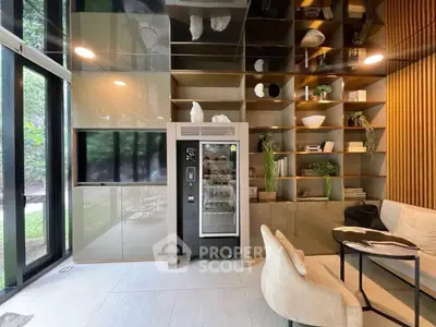 Modern living room with sleek shelving, cozy seating, and large windows overlooking greenery.