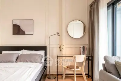 Modern bedroom with stylish decor and natural light, featuring a cozy bed and elegant workspace.