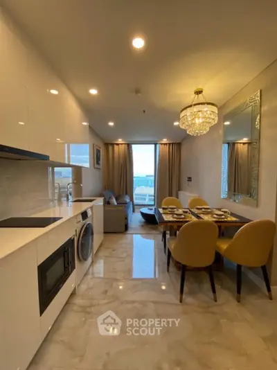 Luxurious modern kitchen and dining area with elegant chandelier and open layout