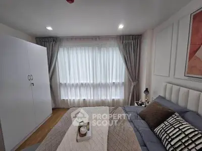 Cozy bedroom with modern decor and large window with curtains