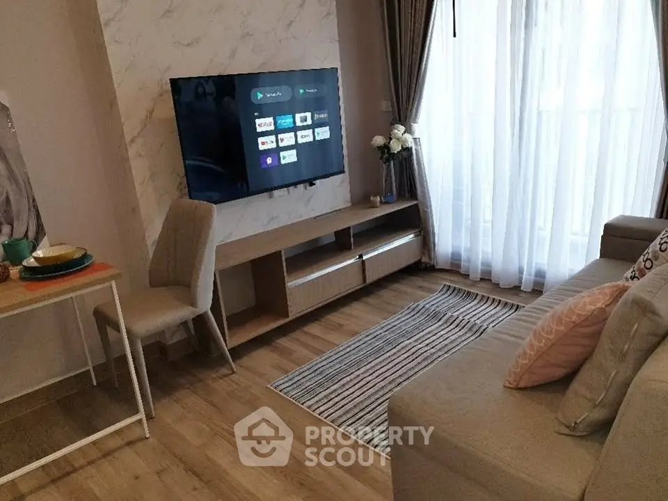 Modern living room with wall-mounted TV, cozy sofa, and elegant decor