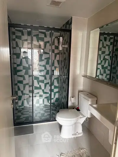 Modern bathroom with geometric shower design and sleek fixtures