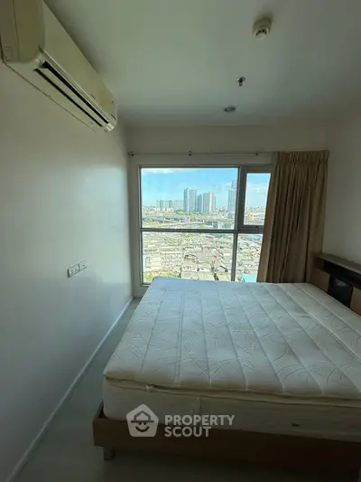 Spacious bedroom with city view and air conditioning in modern apartment.
