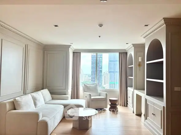Elegant living room with modern furniture and city view, featuring built-in shelves and natural light.
