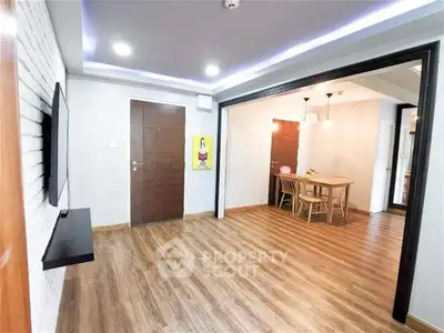 Spacious modern living room with wooden flooring and open dining area