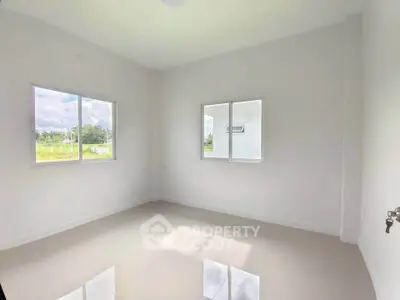 Bright empty room with large windows and glossy floor, perfect for customization.