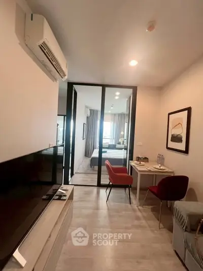 Modern apartment interior with open layout, featuring a cozy living area and stylish bedroom.