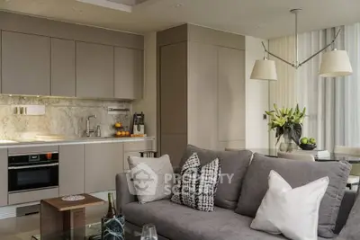 Modern open-layout kitchen and living room with stylish decor and neutral tones.