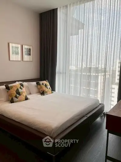 Modern bedroom with large window and stylish decor in urban apartment