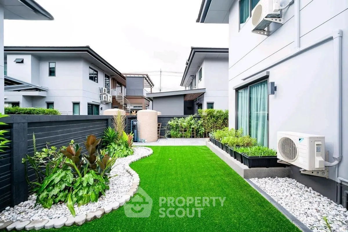 Modern backyard with lush garden and artificial grass in suburban home