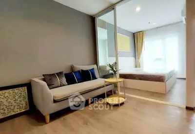 Modern studio apartment with cozy living area and bedroom, featuring stylish decor and natural light.
