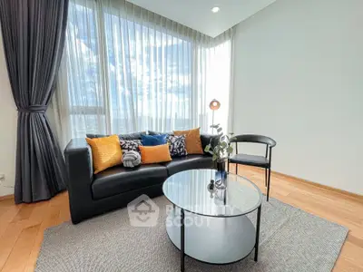 Modern living room with stylish decor and large windows offering a stunning view.