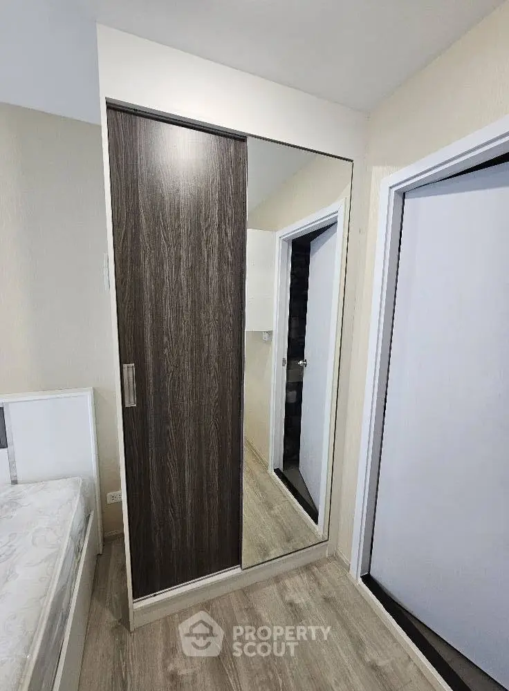 Modern bedroom with sleek sliding wardrobe and stylish flooring