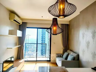 Modern living room with stylish lighting and balcony view in high-rise apartment.