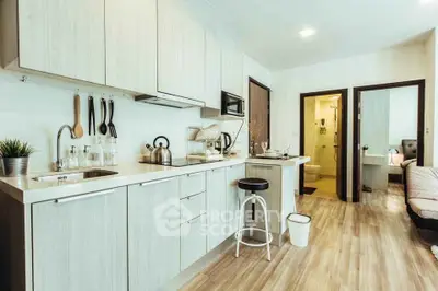 Modern kitchen with sleek cabinetry and open layout in stylish apartment