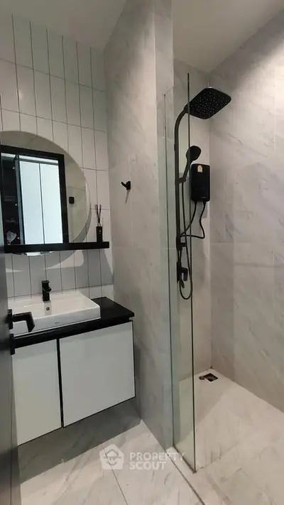 Modern bathroom with sleek design featuring a glass shower and stylish vanity.