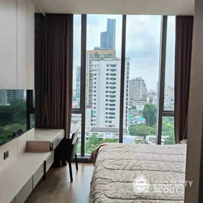 Modern bedroom with floor-to-ceiling windows offering stunning city views