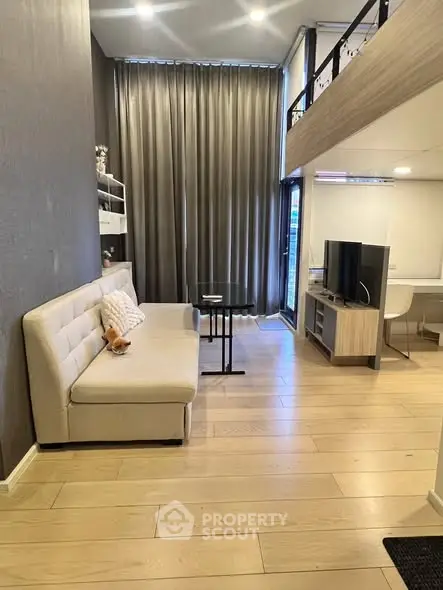 Modern loft-style living room with high ceilings and elegant decor.