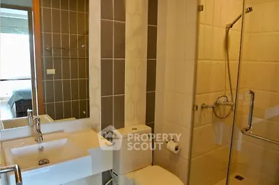 Modern bathroom with glass shower and sleek fixtures in a stylish apartment.