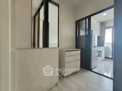 Modern apartment interior with sleek kitchen and ample storage space