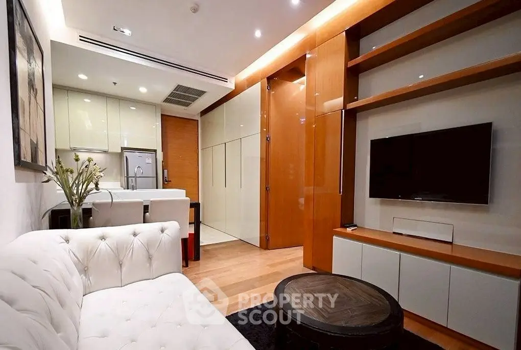 Modern living room with elegant white sofa and sleek wooden shelving