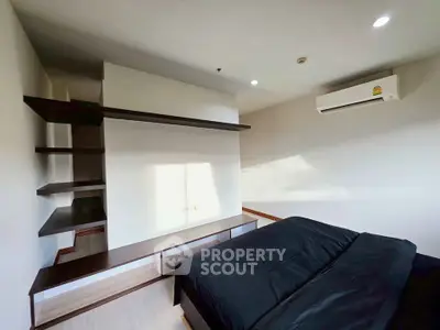 Modern bedroom with sleek shelving and air conditioning, perfect for comfort and style.