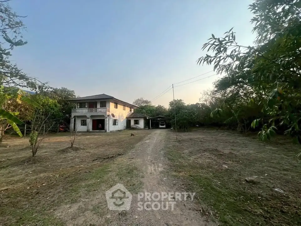 Charming countryside property with spacious yard and two-story house, ideal for serene living.