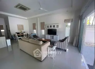 Spacious living room with modern furniture and open layout, perfect for family gatherings.