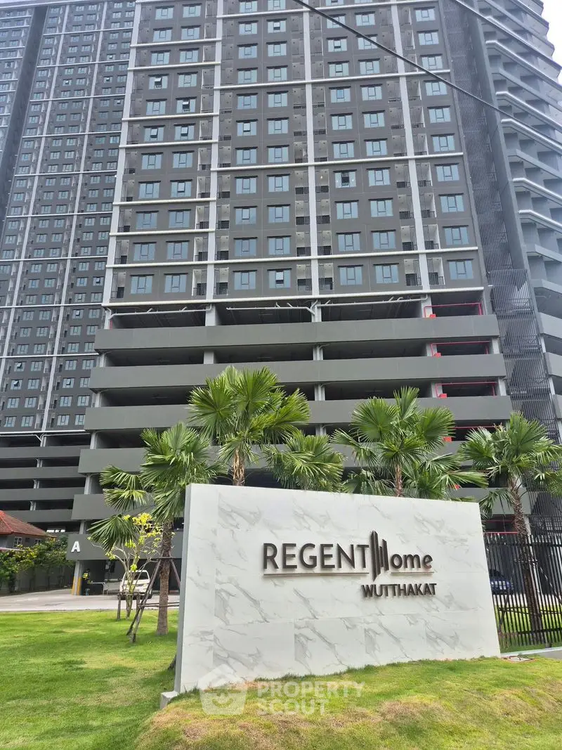 Modern high-rise building with lush landscaping at Regent Home Muttahkat
