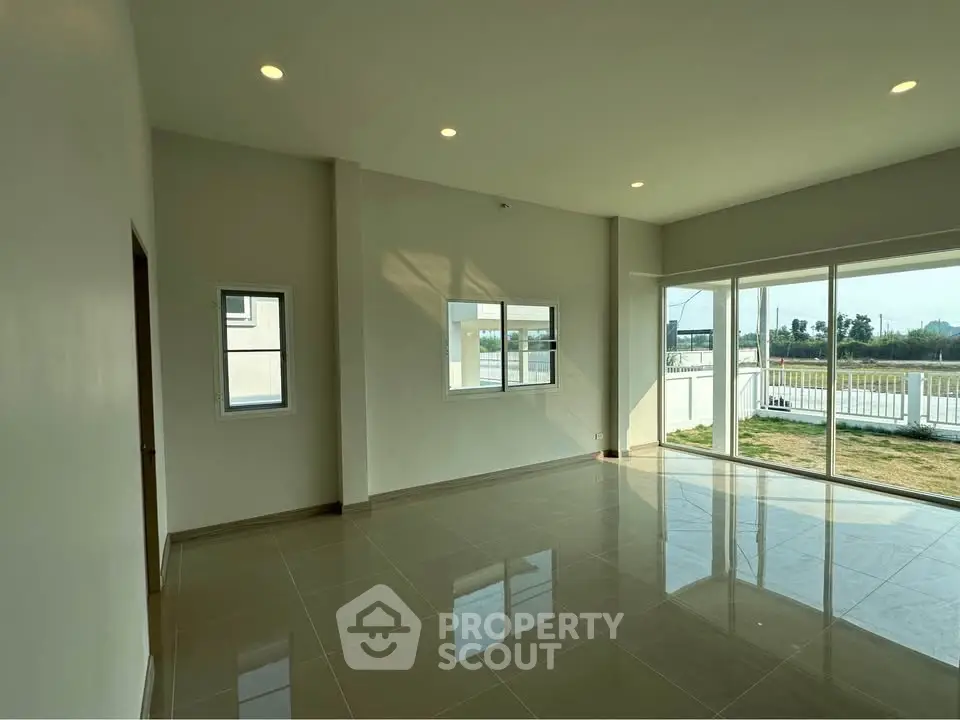 Spacious living room with large windows and natural light in modern home