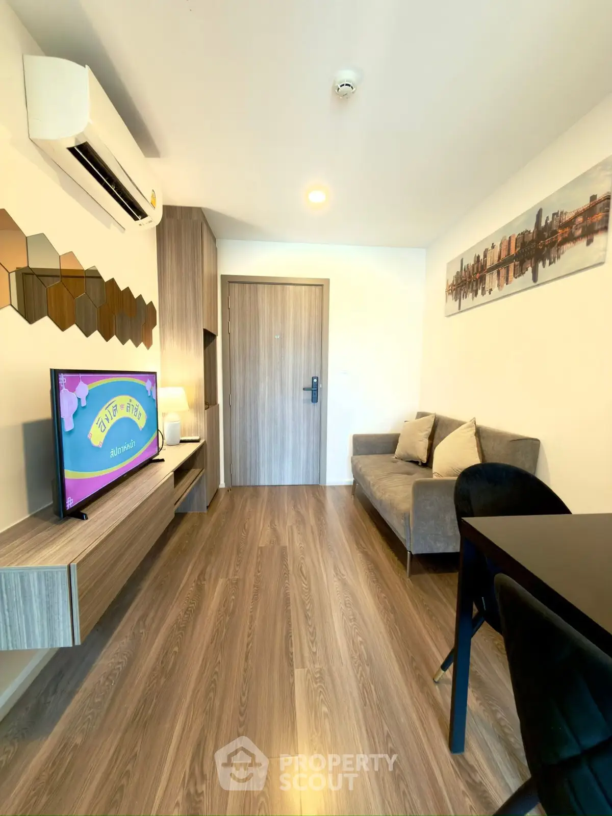 Modern living room with stylish decor and wooden flooring in a cozy apartment.
