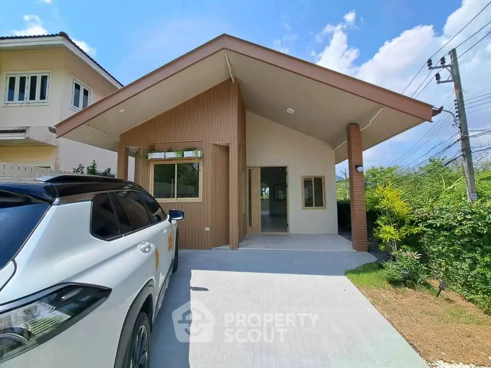 Charming single-story home with modern design and spacious driveway in a serene neighborhood.