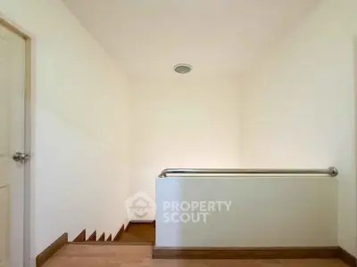 Minimalist interior stairway with sleek handrail and wooden steps