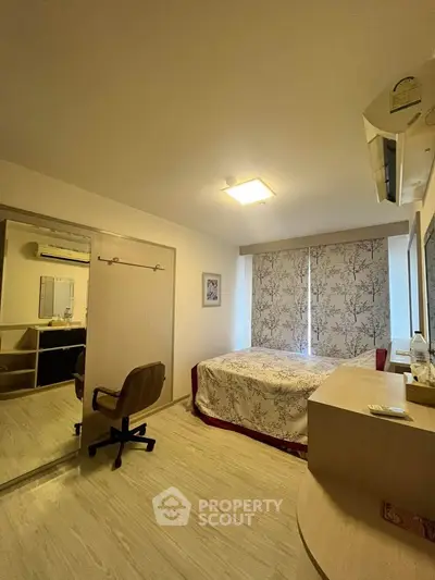 Cozy bedroom with modern decor and ample natural light