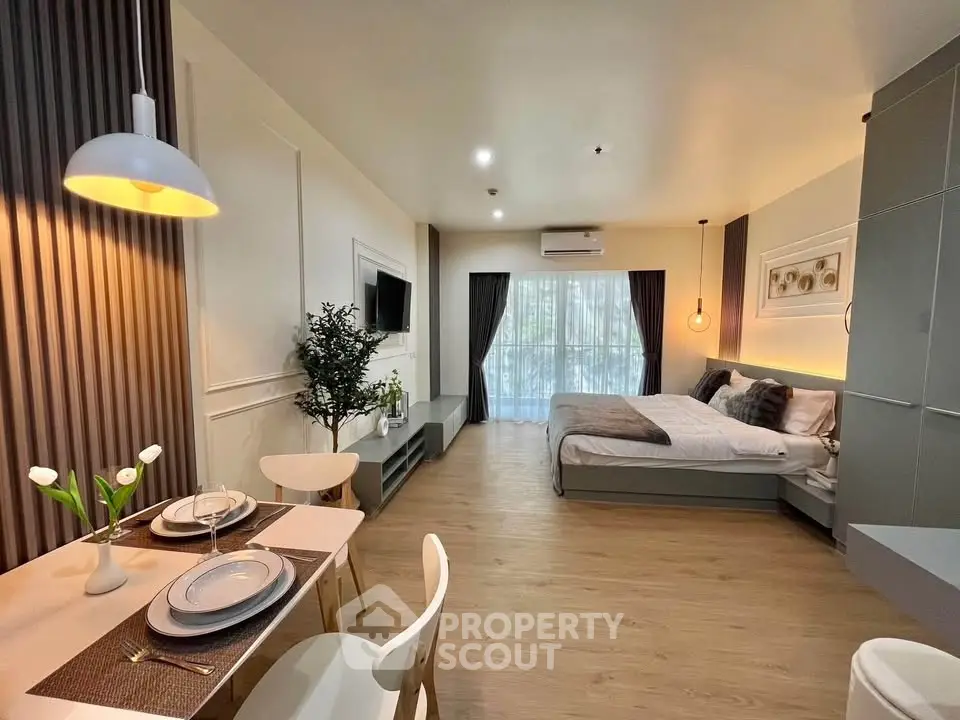 Modern studio apartment with open layout, stylish decor, and natural light.