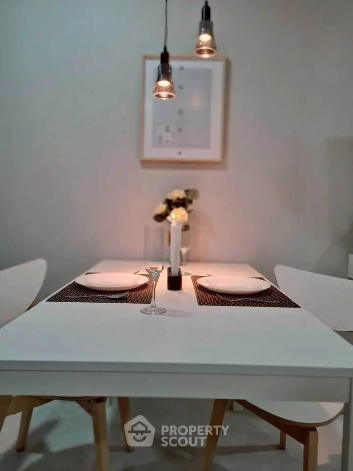 Modern dining area with elegant table setting and stylish lighting.