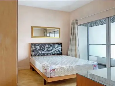 Modern bedroom with balcony access and stylish decor in a contemporary apartment.