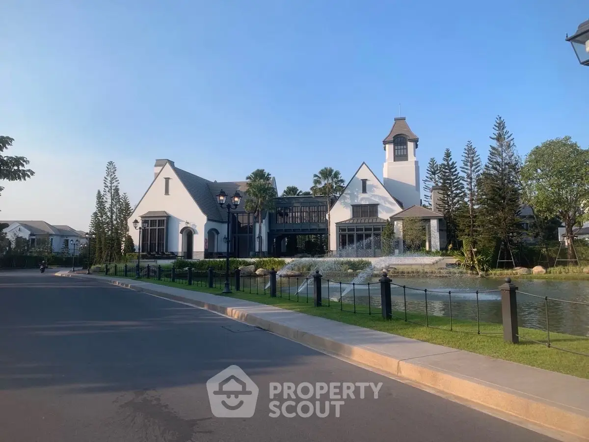 Stunning estate with elegant architecture and serene water feature, perfect for luxury living.