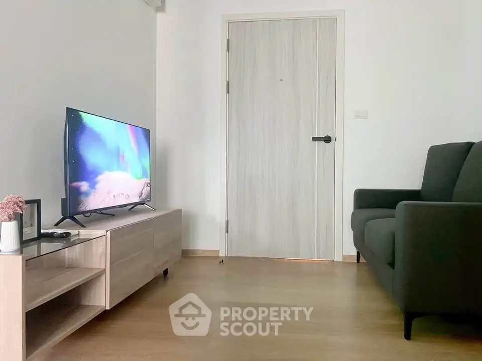 Modern living room with sleek TV setup and comfortable sofa, perfect for relaxation.