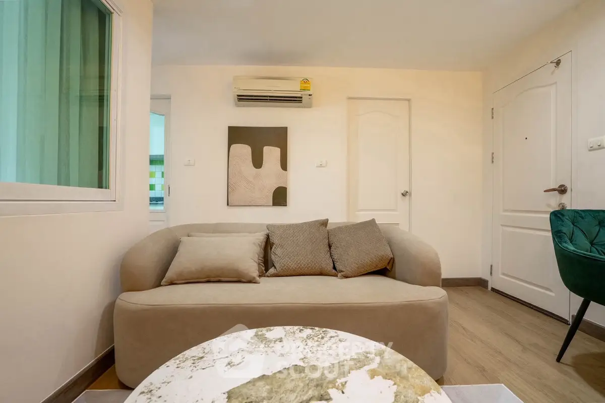 Cozy living room with modern decor and air conditioning in a stylish apartment.