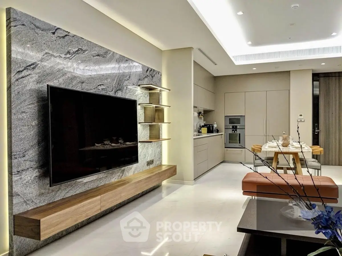 Luxurious modern living room with open kitchen, featuring sleek design and high-end finishes.